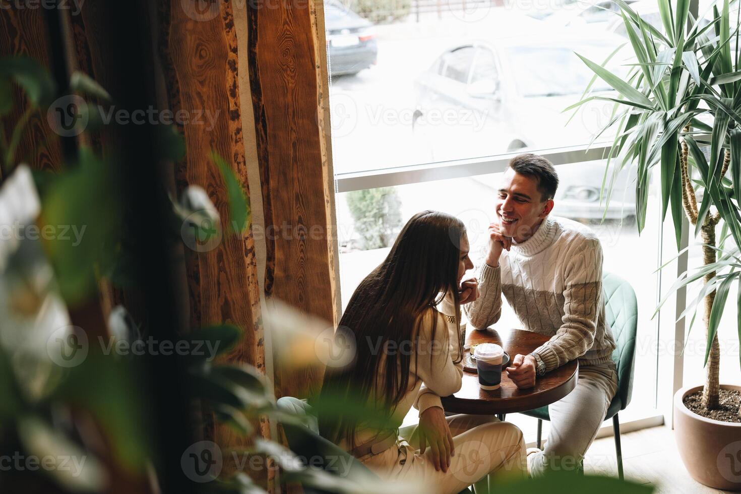 Man and Woman Sitting at Table Talking photo