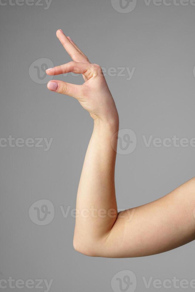Woman Holding Arm Up in the Air with Gesture photo
