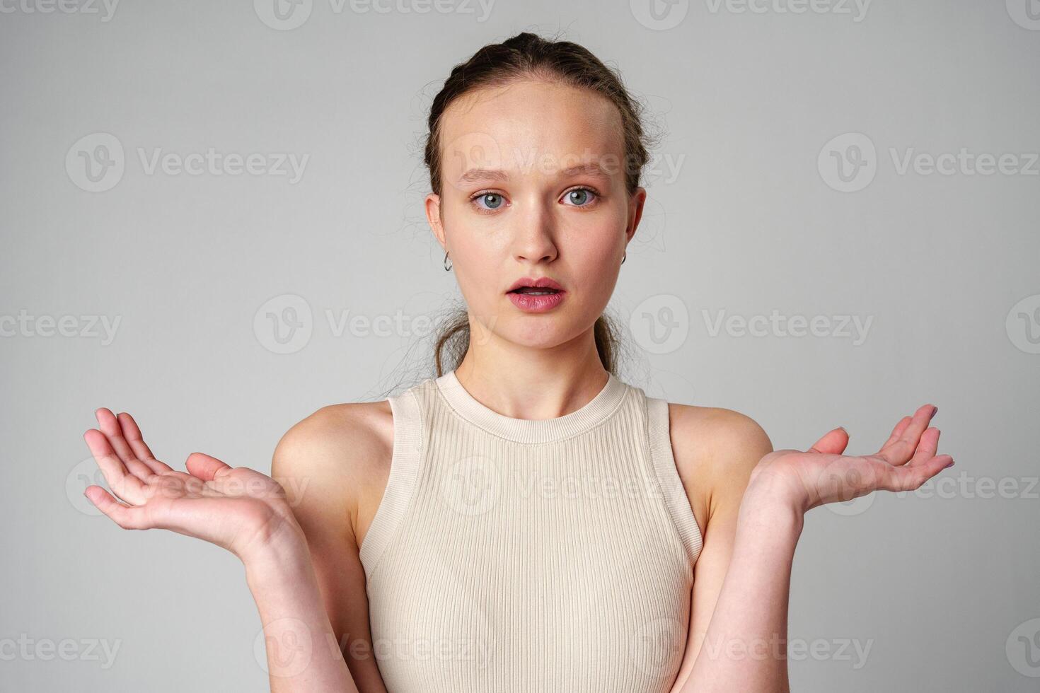 Startled Woman With Surprised Expression on gray background photo