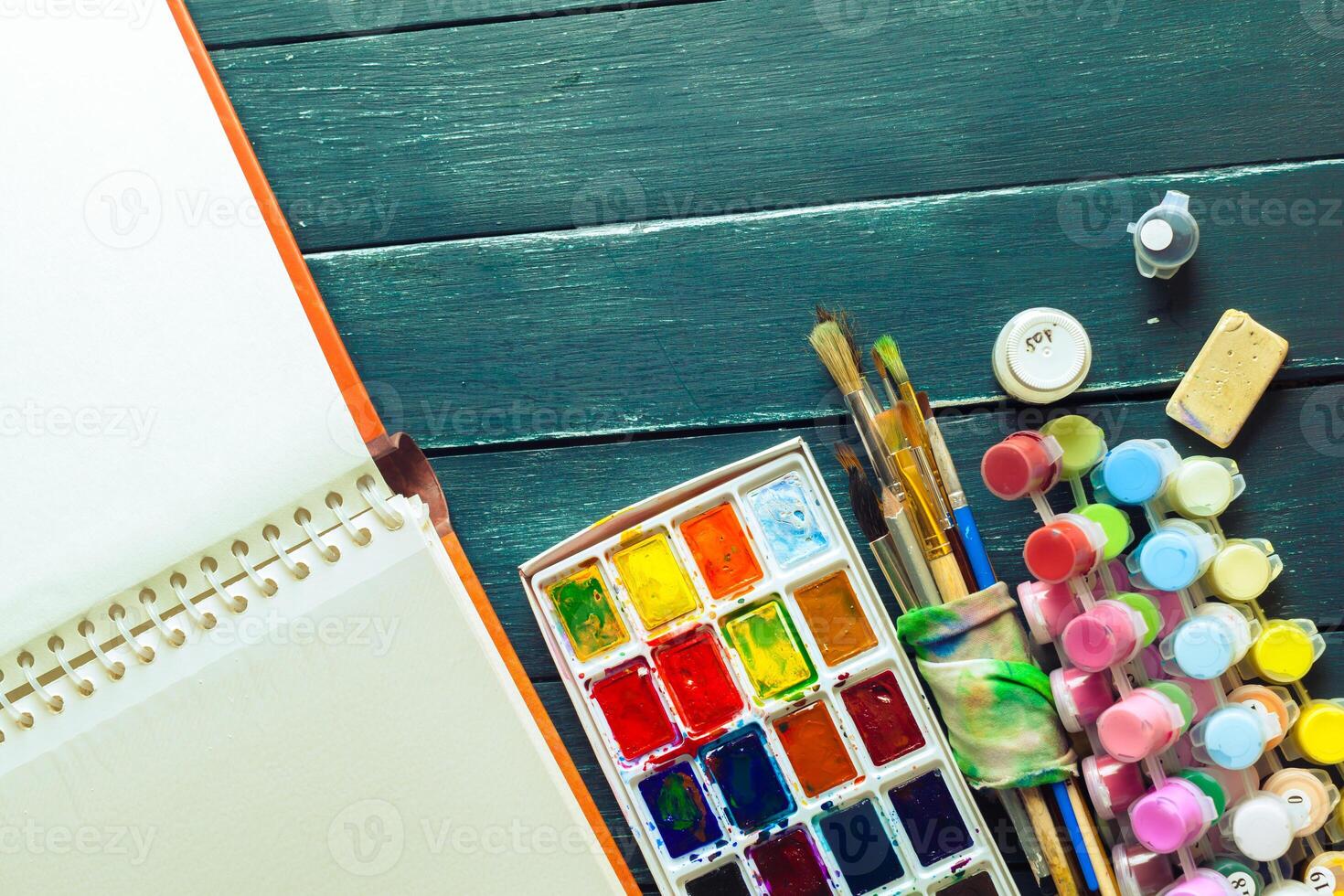 Set of watercolor paints and paintbrushes for painting photo