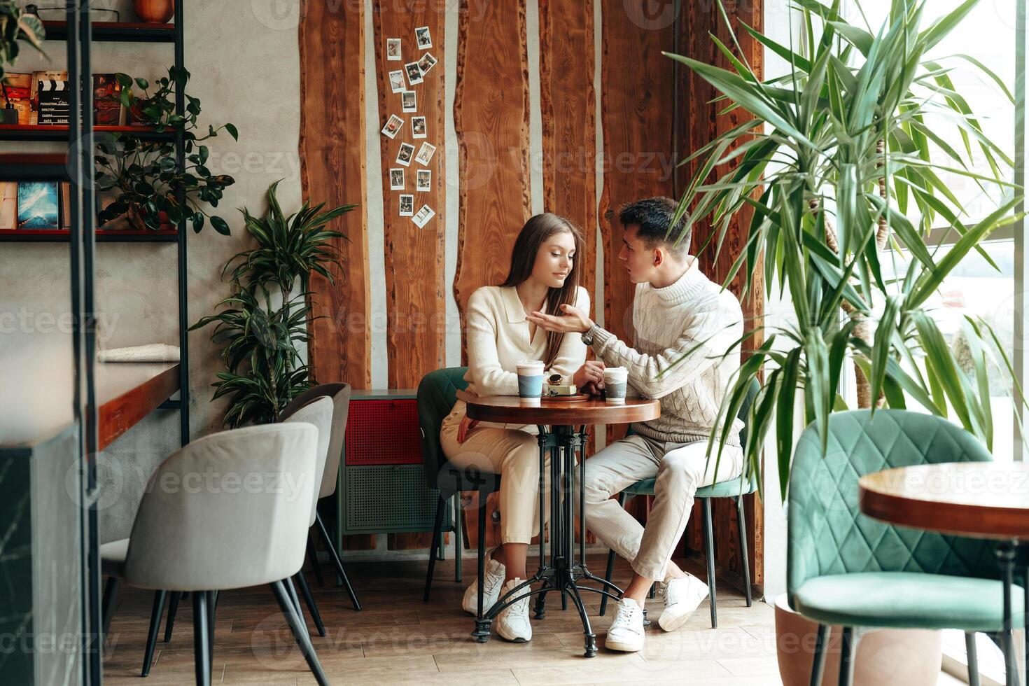 Young Couple Enjoying a Coffee Date at a Cozy Cafe During Afternoon Hours photo