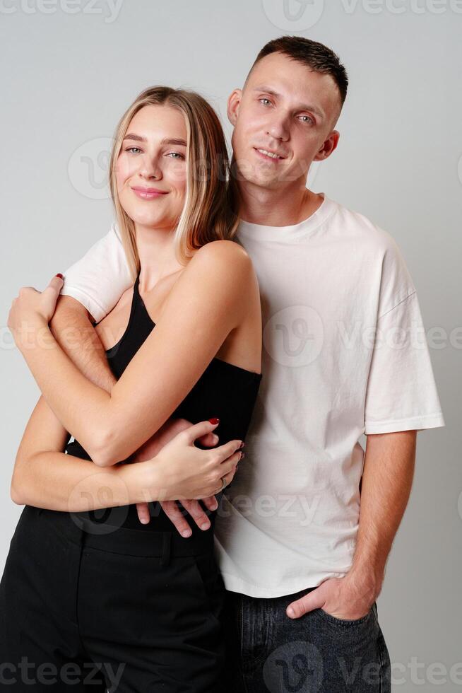 A Man and a Woman Standing Next to Each Other in studio photo