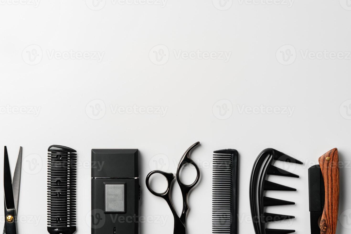 Set of barber tools for haircut on gray background flat lay photo