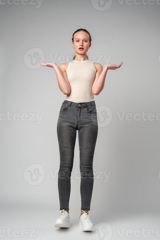 Startled Woman With Surprised Expression on gray background photo