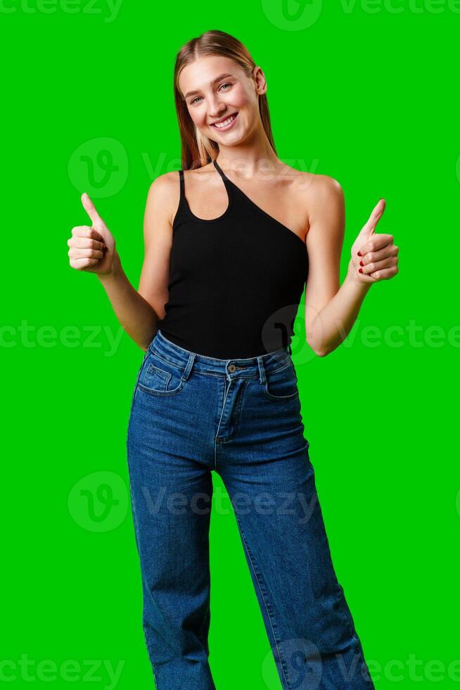 Young Woman Giving Thumbs Up Sign on Green Screen photo