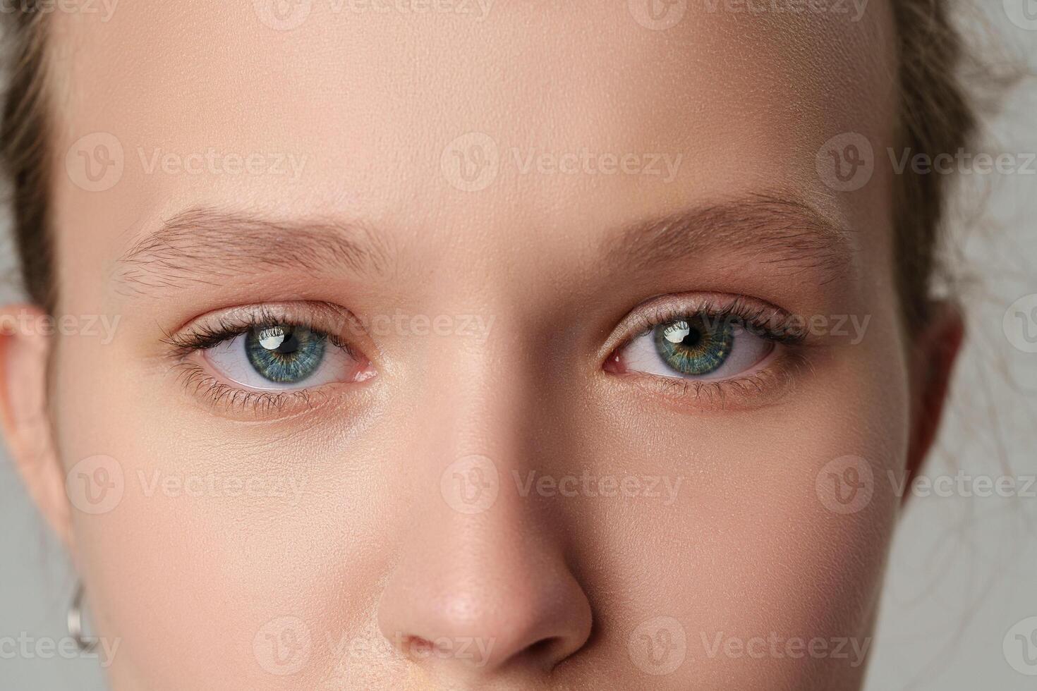 Close up of young female blue eyes photo