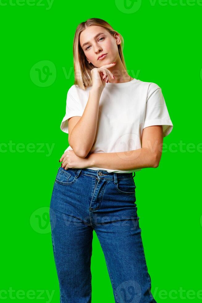 Young Woman in White Shirt Posing for Picture against green background photo