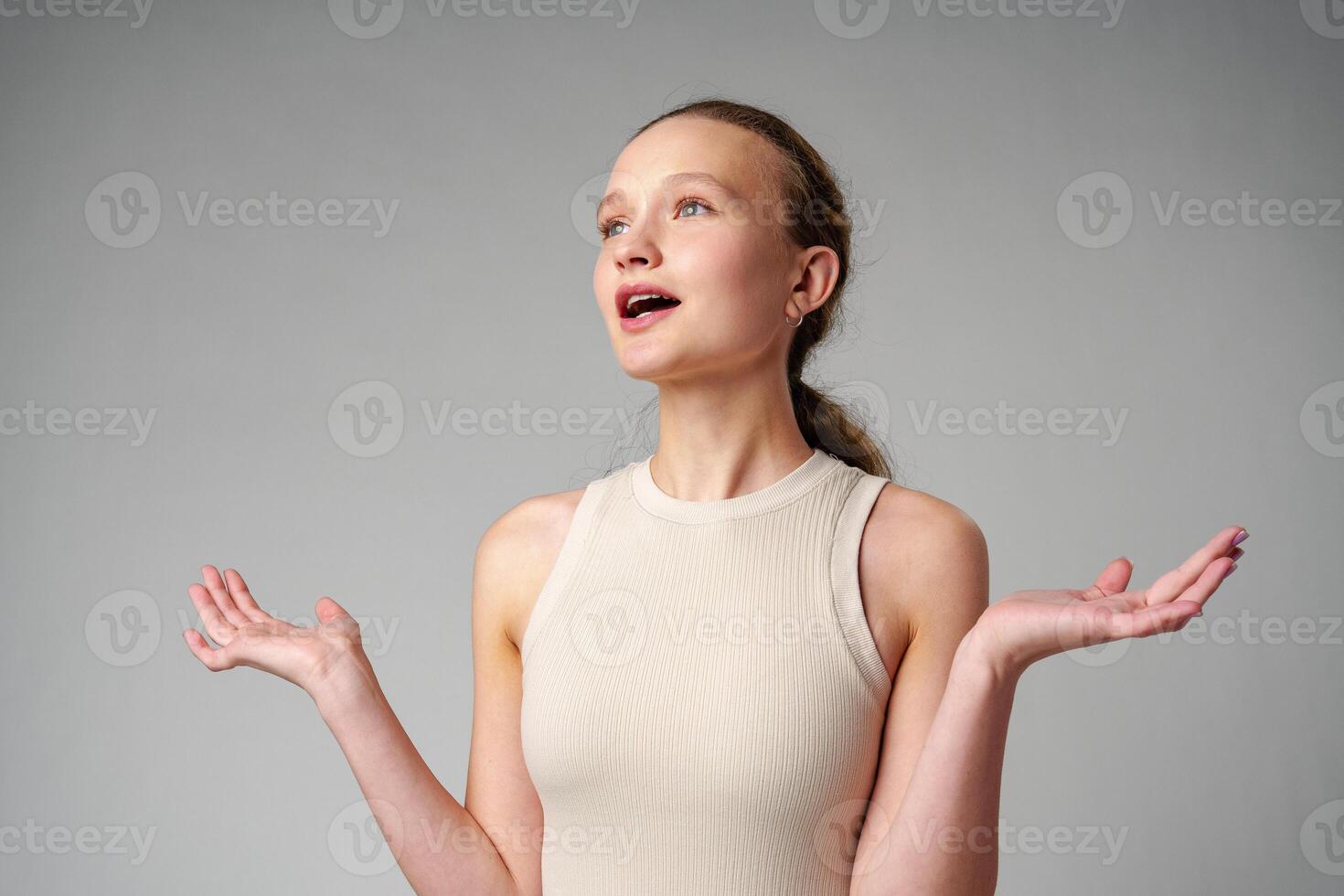 Startled Woman With Surprised Expression on gray background photo