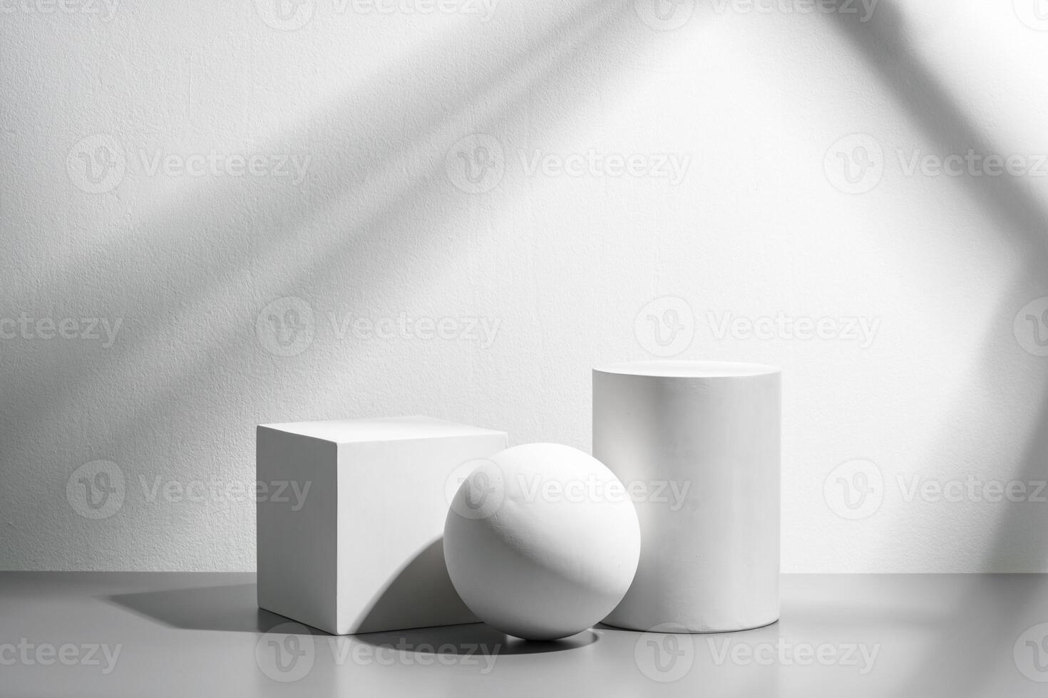 Abstract composition featuring three white geometric shapes in a minimalist interior setting photo