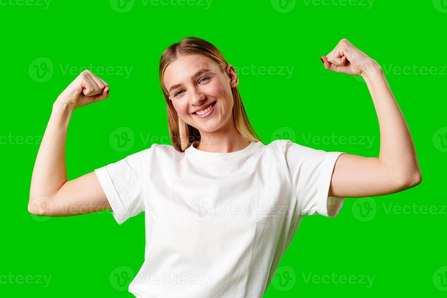 Happy Young Woman Raising Fists against green background photo