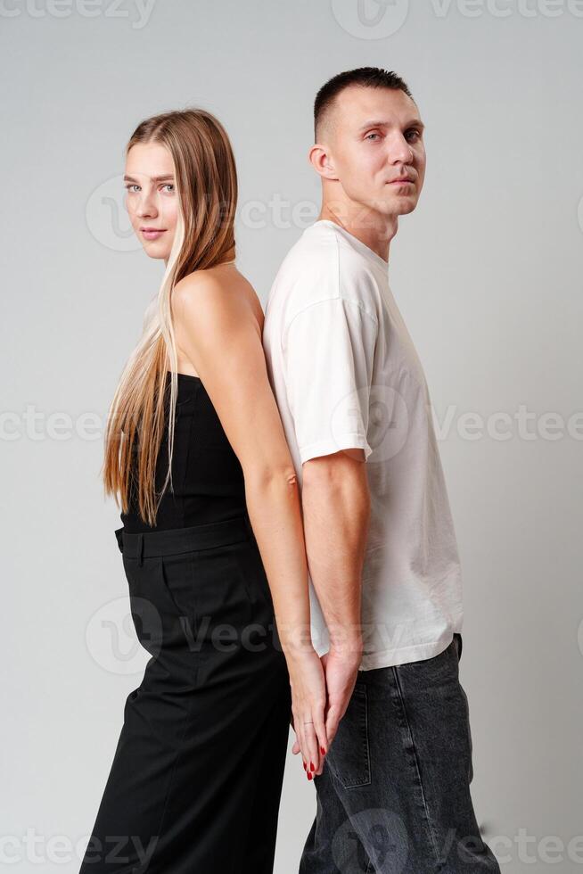 A Man and a Woman Standing Next to Each Other in studio photo
