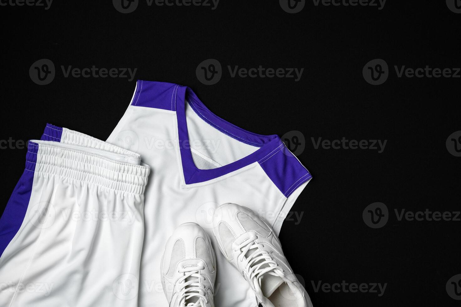 Basketball Outfit and Accessories Laid Out on Dark Background photo
