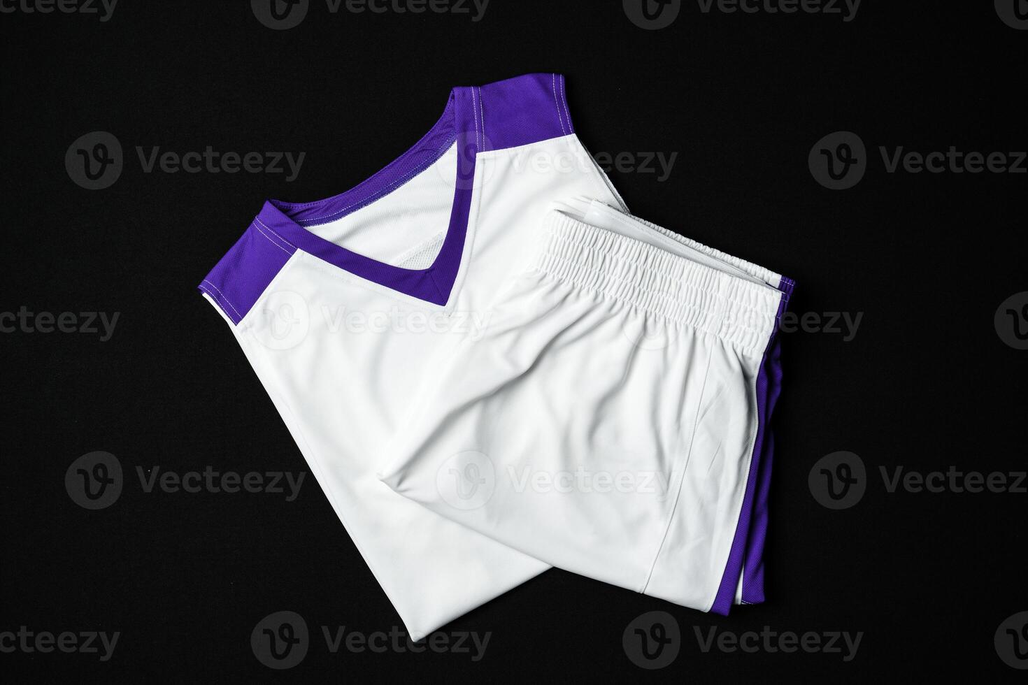 White and Purple Athletic Tank Top Laid Flat on Black Background photo