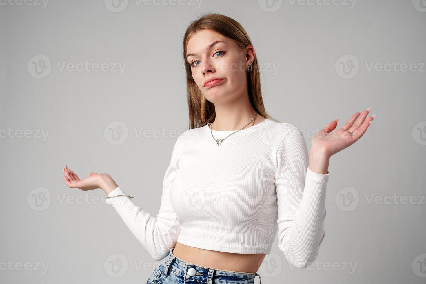 Young Woman in Blue Top Holding Out Hands photo