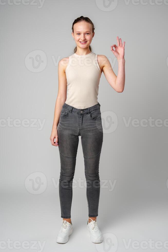 Young Girl Giving Thumbs Up Sign in studio photo