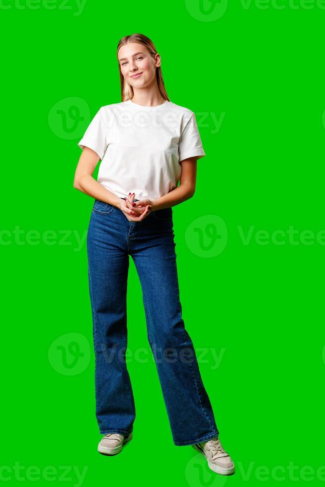 Young Woman in White Shirt Posing for Picture against green background photo