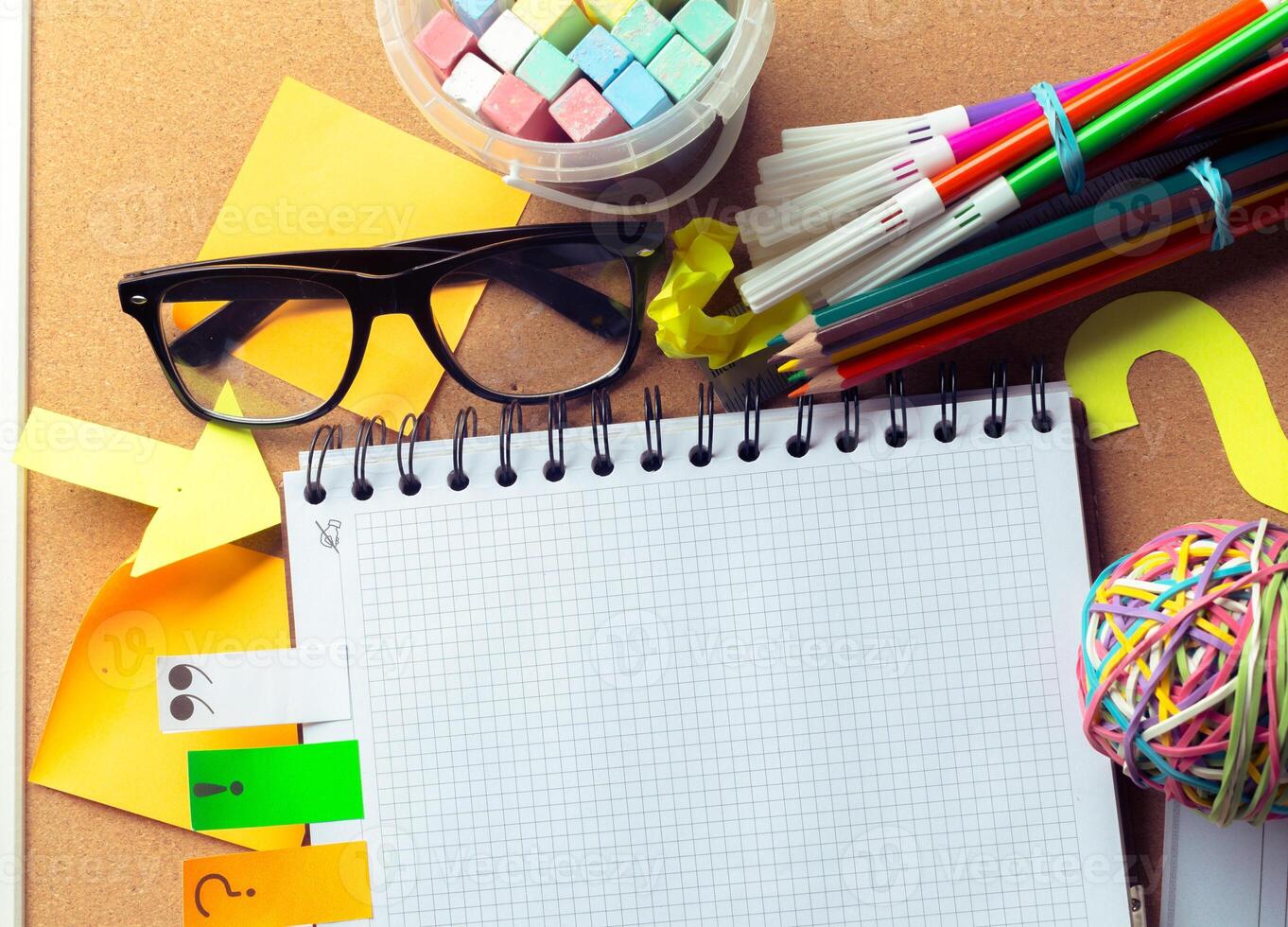Desk of an artist with lots of stationery objects photo
