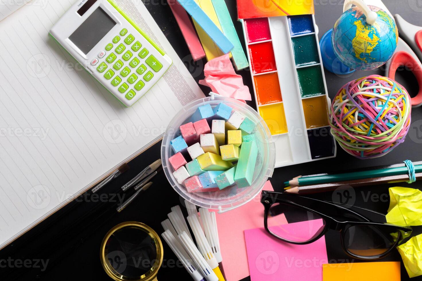 Desk of an artist with lots of stationery objects photo