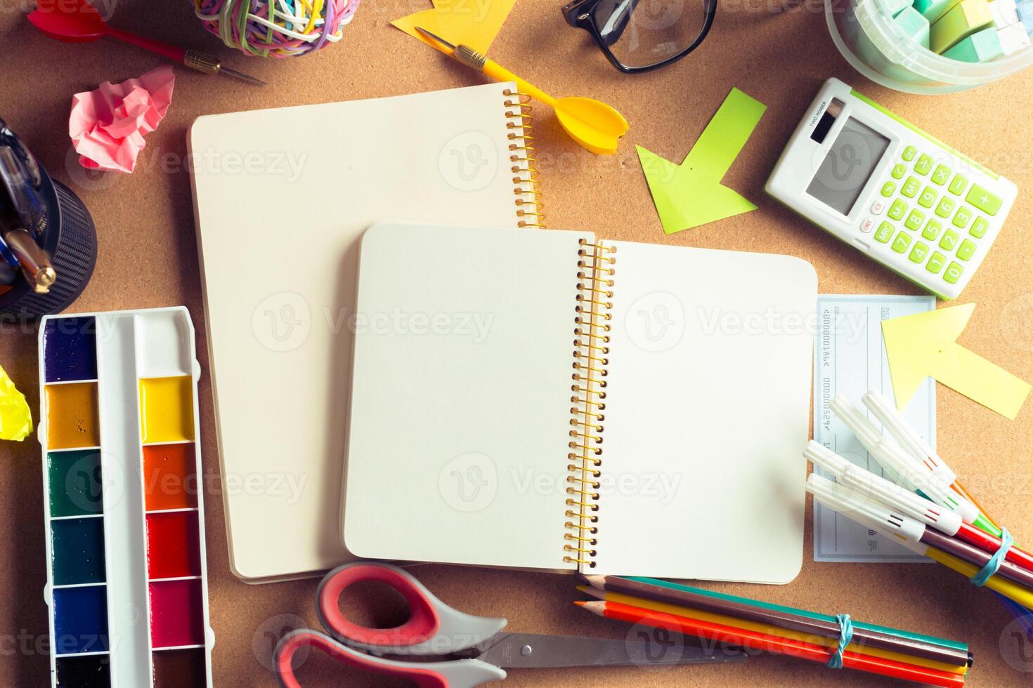 Desk of an artist with lots of stationery objects photo