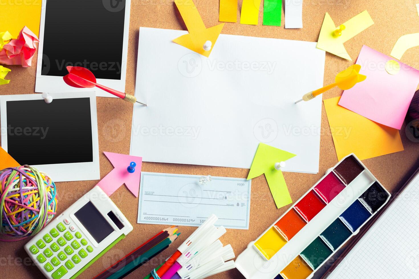 Desk of an artist with lots of stationery objects photo