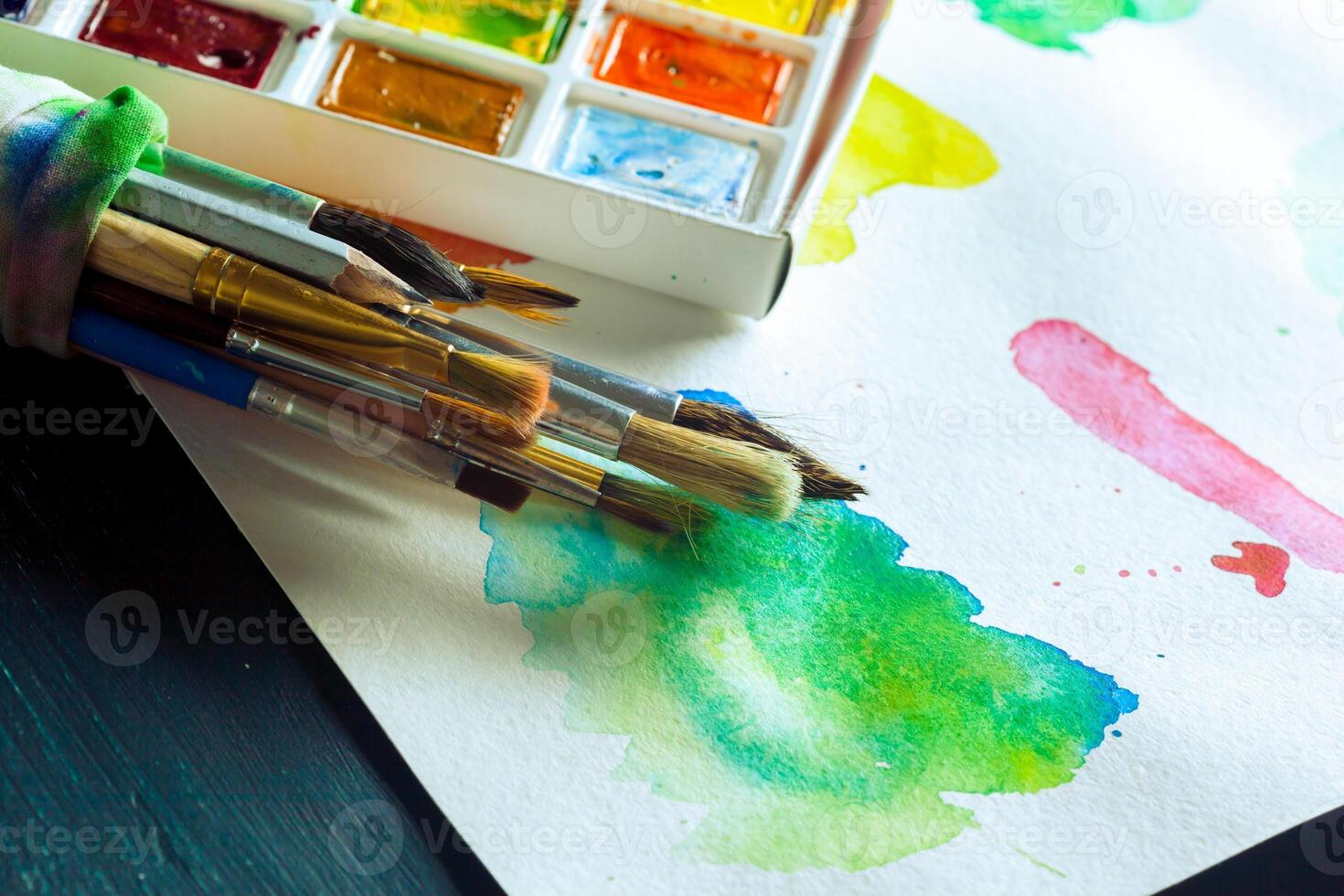 Set of watercolor paints and paintbrushes for painting photo