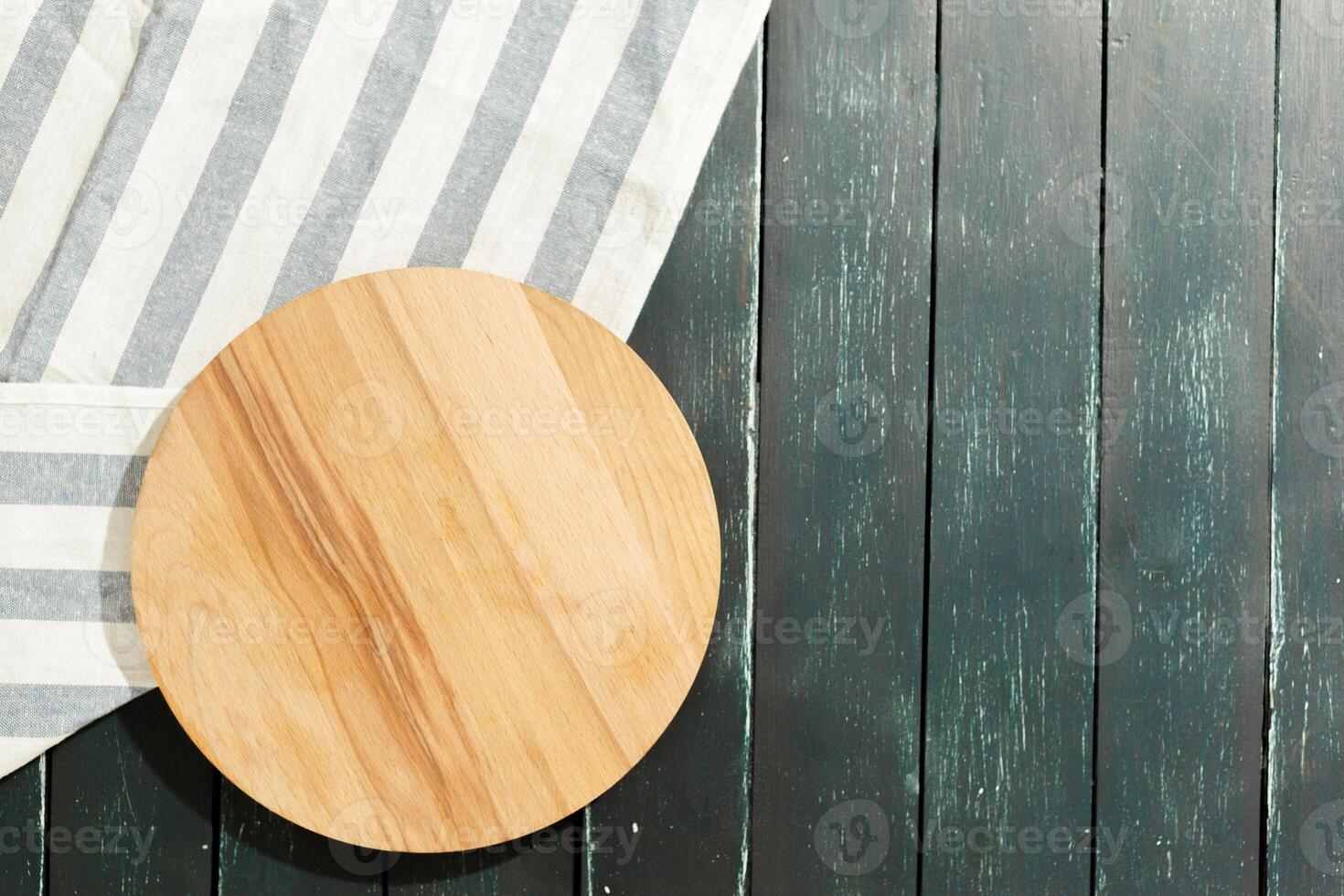empty wooden board with tablecloth on dark desk photo