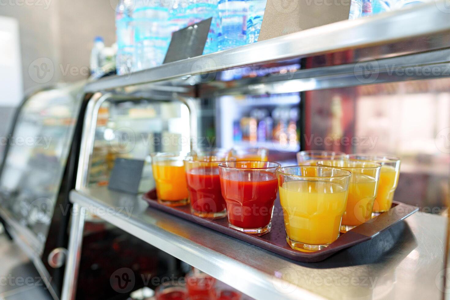 Colorful Array of Fruit Juice Cups on a Serving Cart in a Cafeteria photo