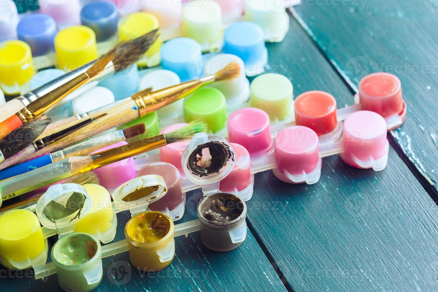 Set of watercolor paints and paintbrushes for painting photo