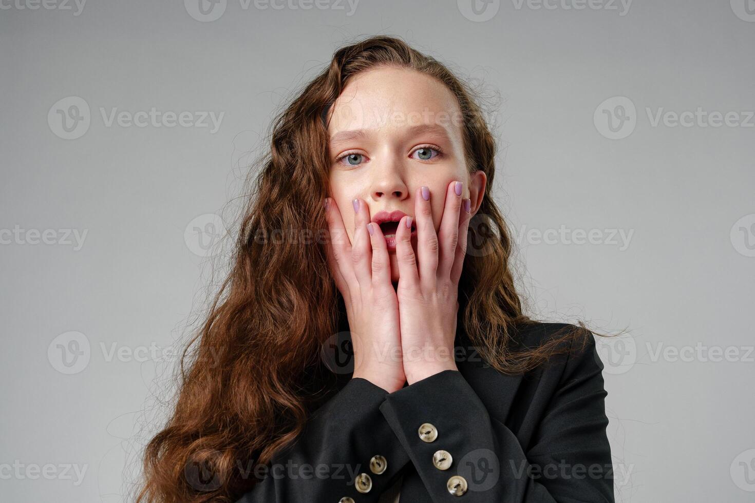 Startled Woman With Surprised Expression on gray background photo