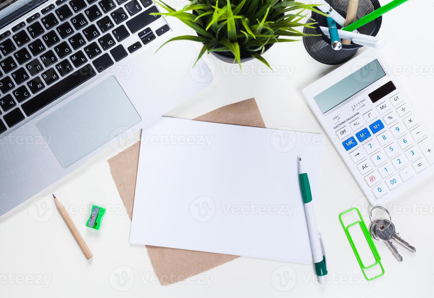 White office desk table with a lot of things on it. Top view photo