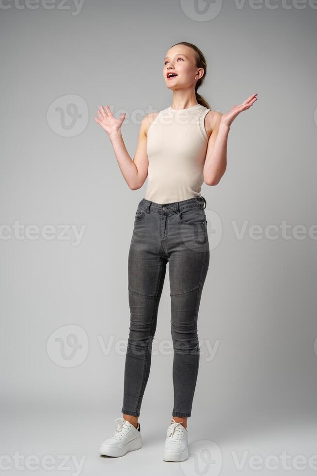 Startled Woman With Surprised Expression on gray background photo