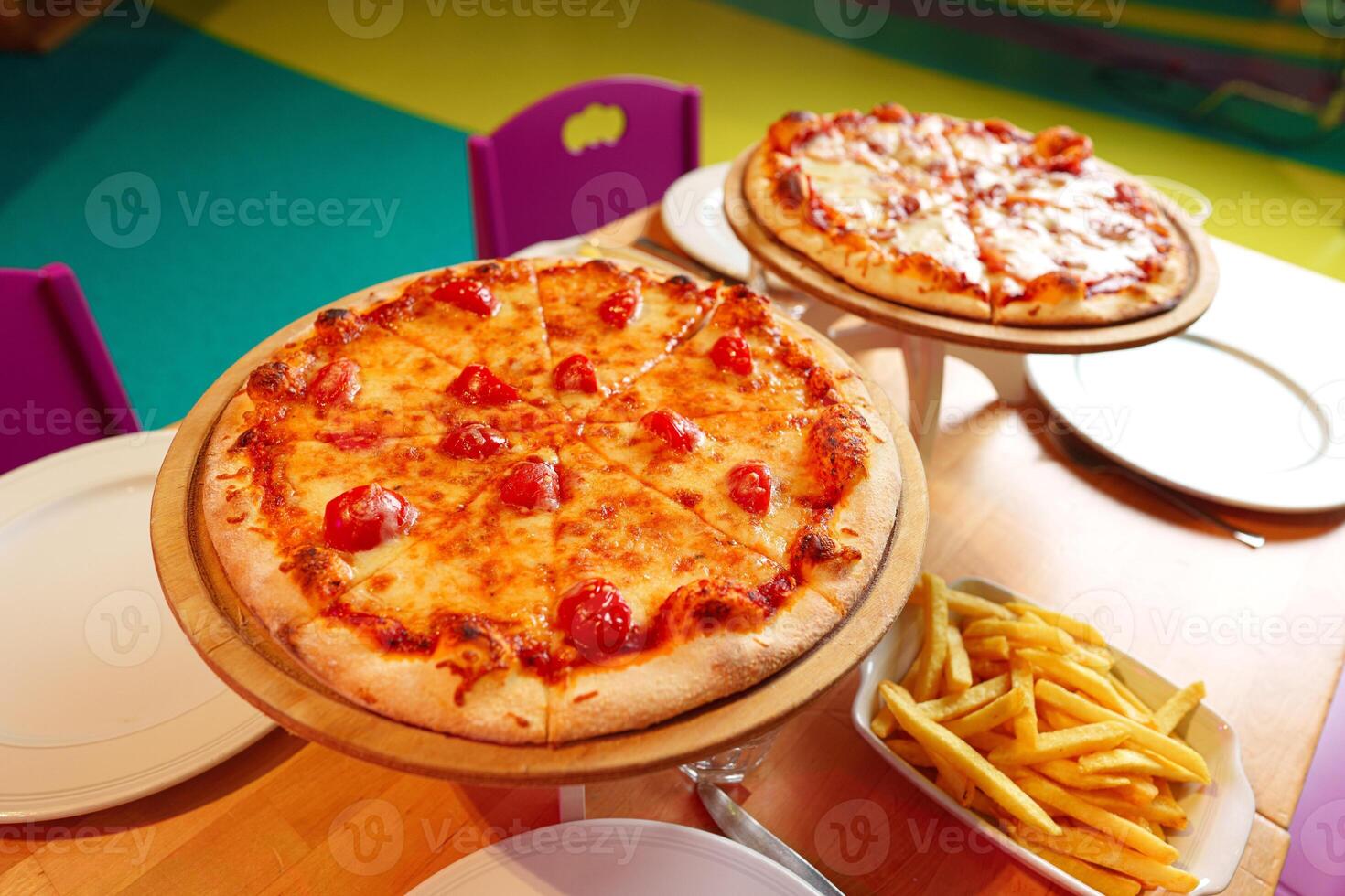Freshly Baked Pizzas Served on Wooden Stands at an Outdoor Party Setting photo