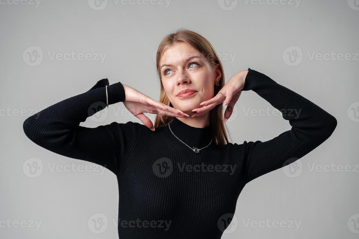 Smiling Woman in Black Top against gray background photo