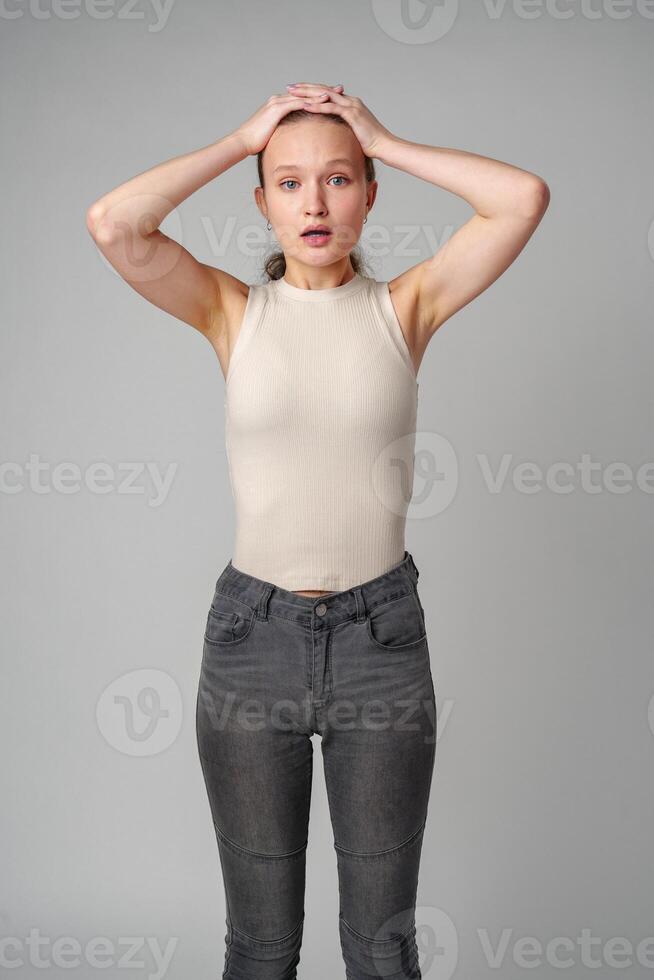 Startled Woman With Surprised Expression on gray background photo