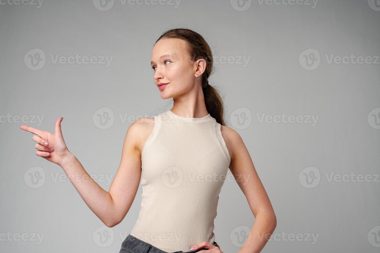 Woman in White Top Pointing at Something photo