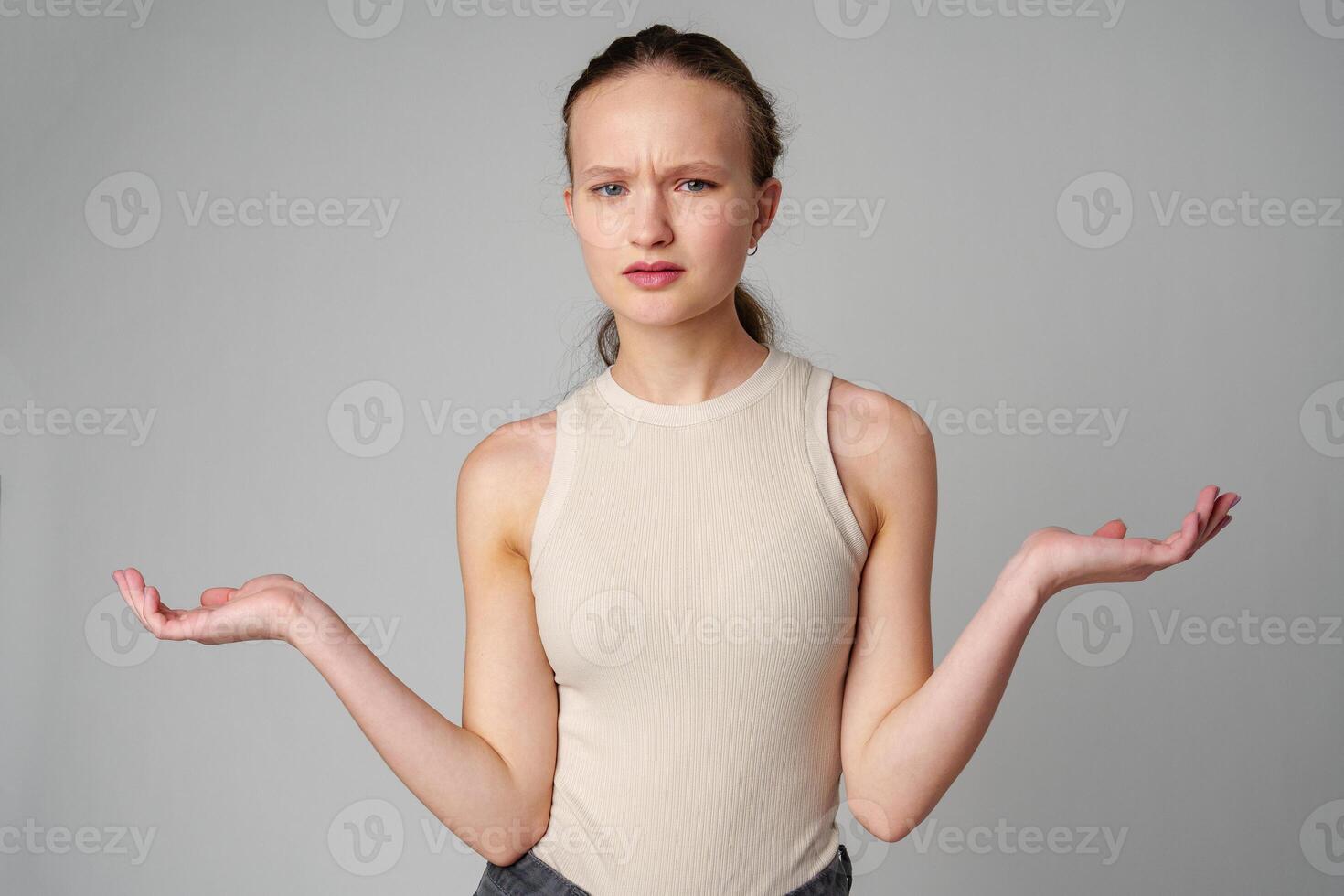 Startled Woman With Surprised Expression on gray background photo