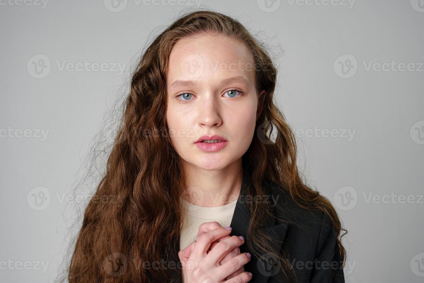 Startled Woman With Surprised Expression on gray background photo