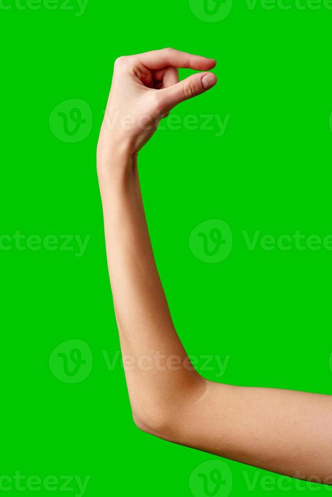 A womans hand extends upward into the air, fingers outstretched, reaching upward towards an unseen destination. photo