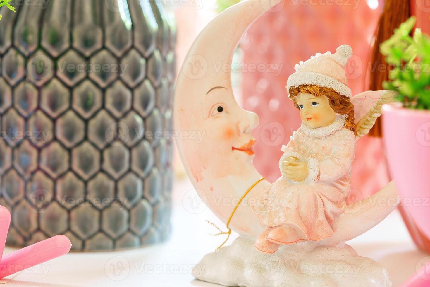 Little Girl Figurine Sitting on the Moon photo