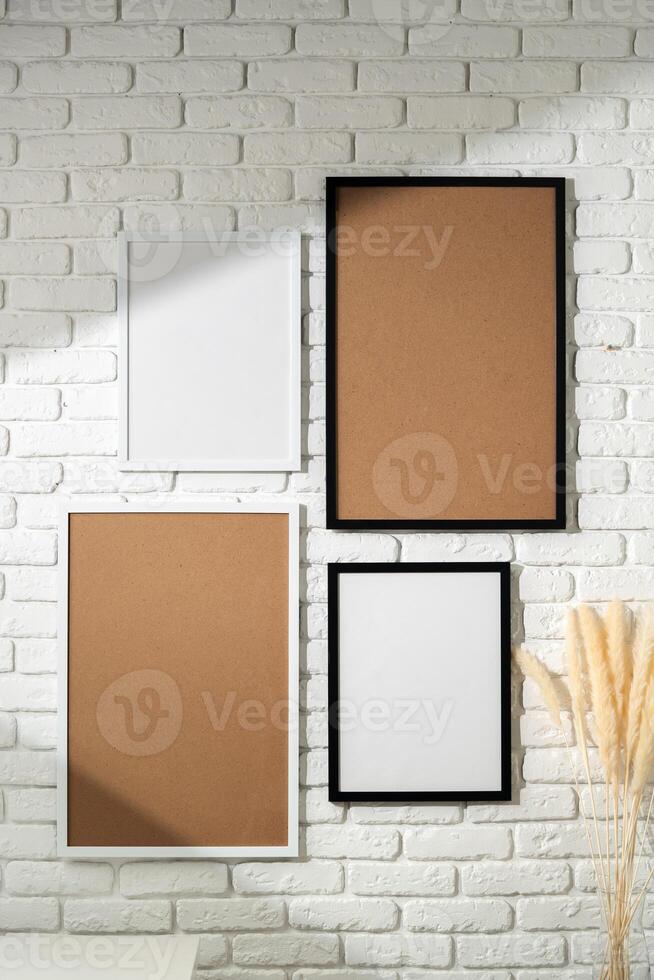 Varied Sized Photo Frames Displayed on a White Brick Wall