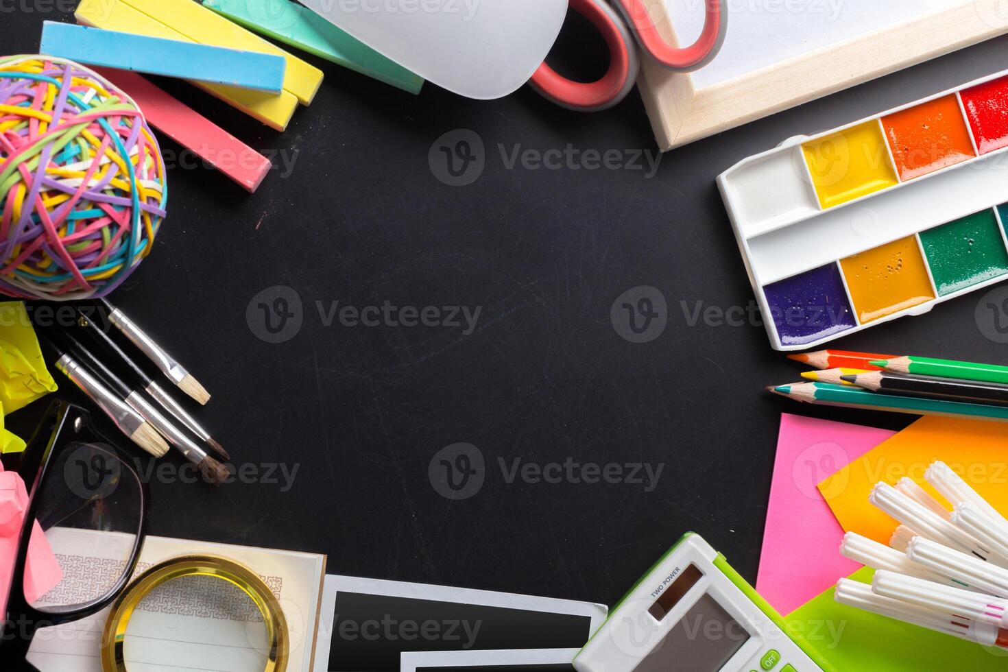 Desk of an artist with lots of stationery objects photo