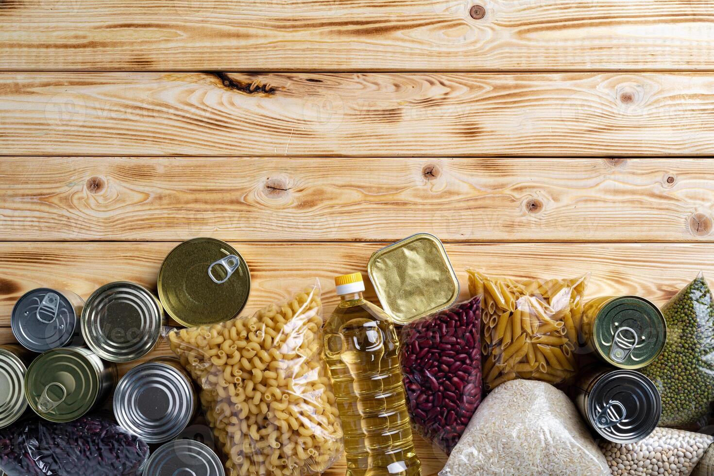 Donations food with canned food on the table background. Donate concept. photo