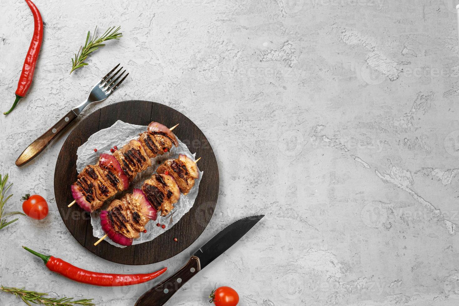 Grilled meat skewers barbecue served on board photo