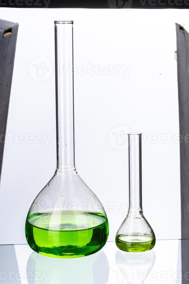 Glassware with liquids for laboratory analysis isolated on white photo