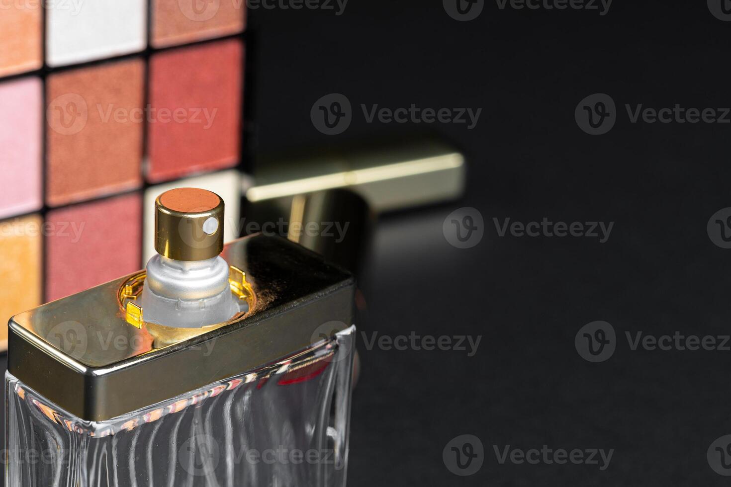 various makeup products on black texture background. photo