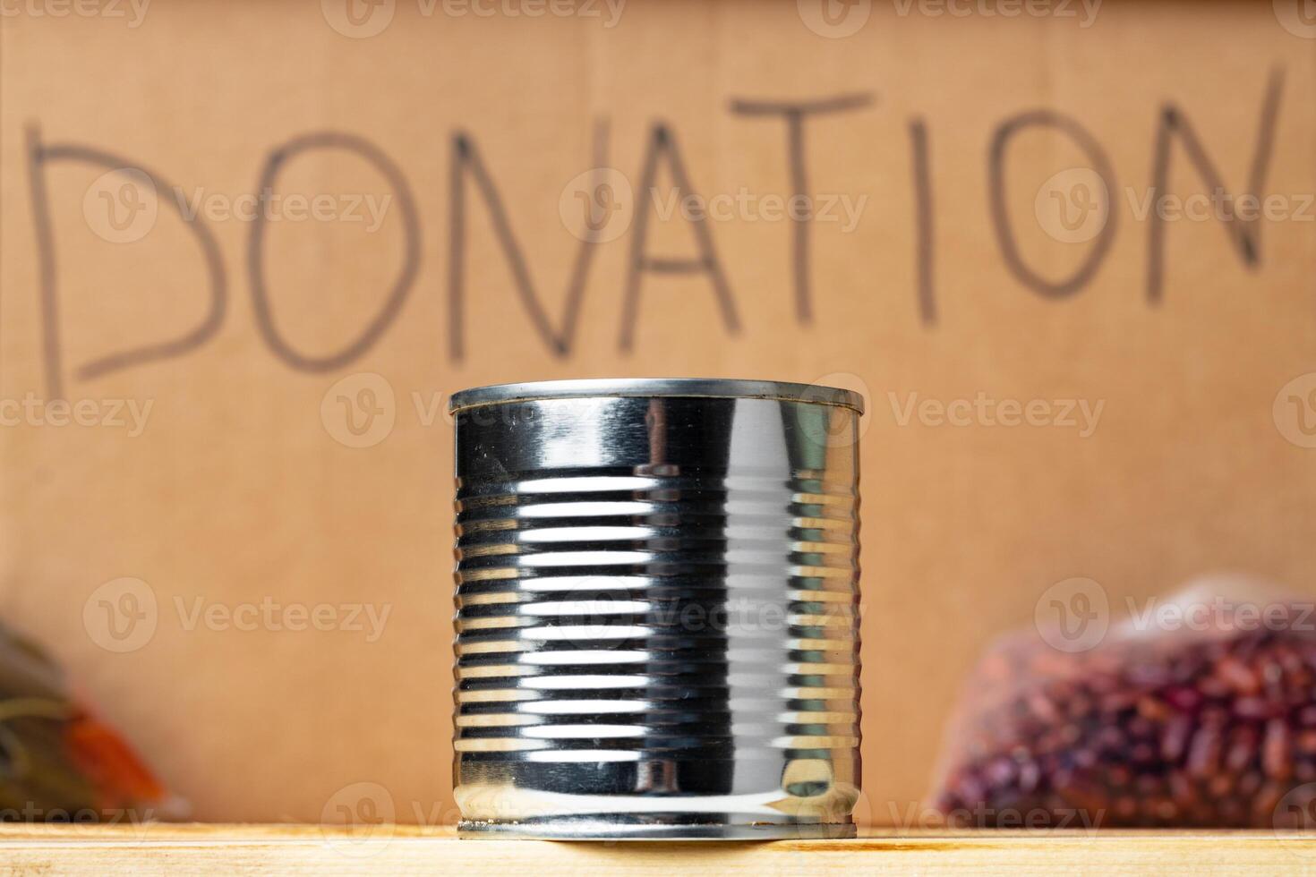 Donations food with canned food on the table background. Donate concept. photo
