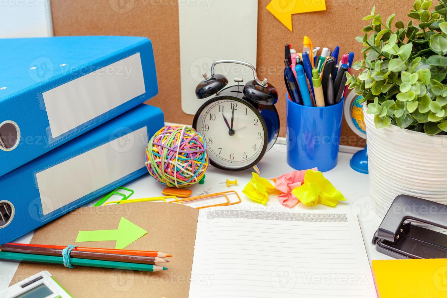 Work place of a creative person with a variety of colorful stationery objects photo