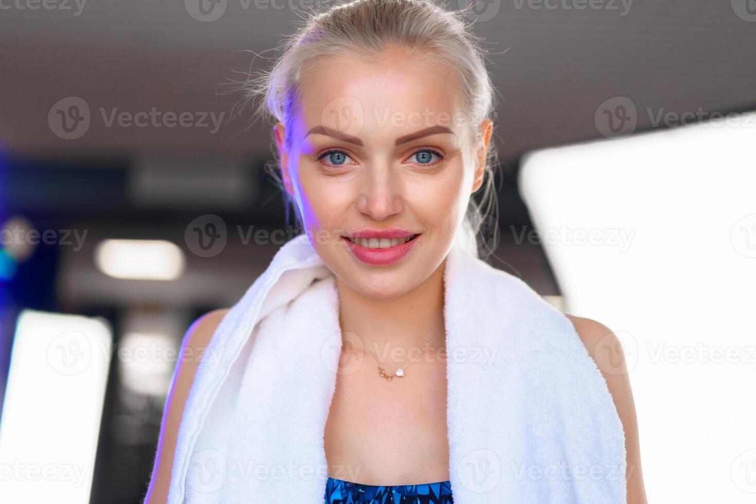 Strong and determined woman in sportswear standing in the gym photo