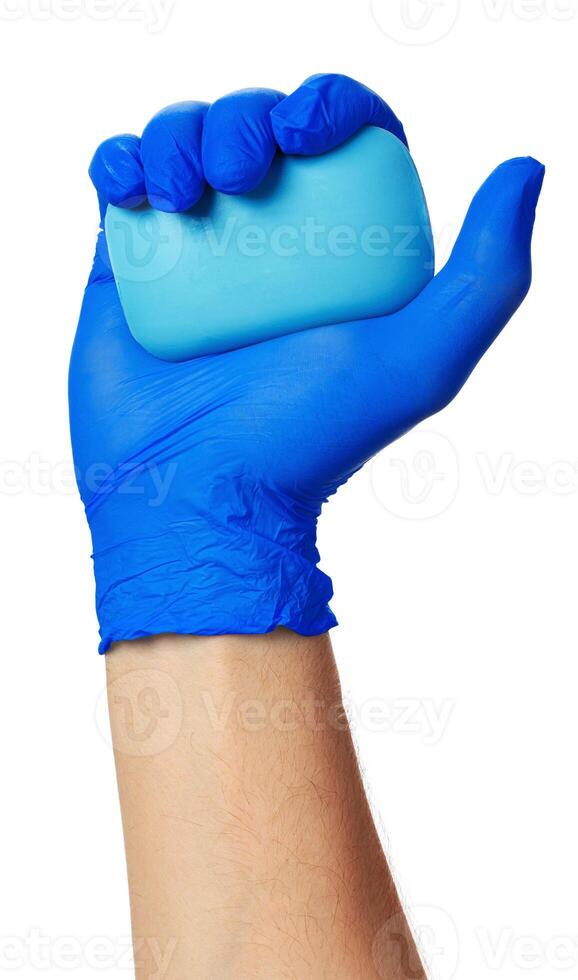hand in a blue glove with a soap on a white background photo