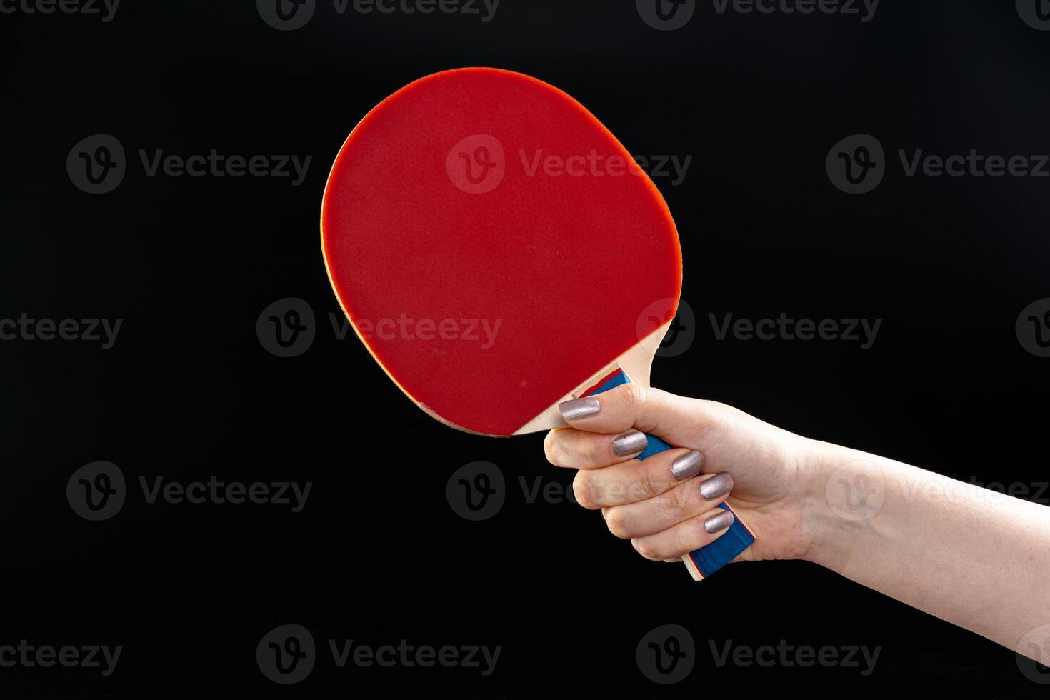 Red ping pong racket on dark background photo